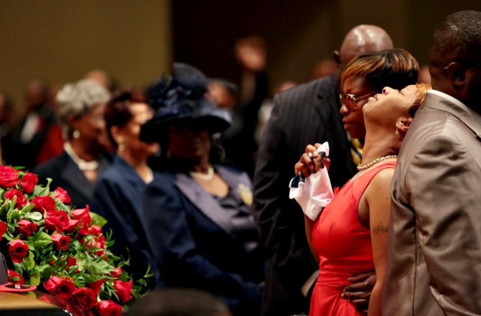 Lesley McSpadden, in red, mourns at the Aug. 25, 2014, funeral service for her son, Michael Brown.