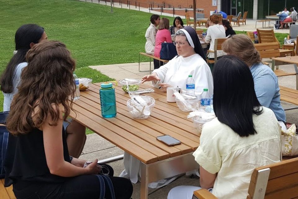Sr. Mary Madeline Todd, center, a Dominican Sister of St. Cecilia and assistant professor of theology at Aquinas College in Nashville, talks with her mentoring group during an afternoon break at the 2021 Given forum. Todd gave a keynote speech June 12 in 