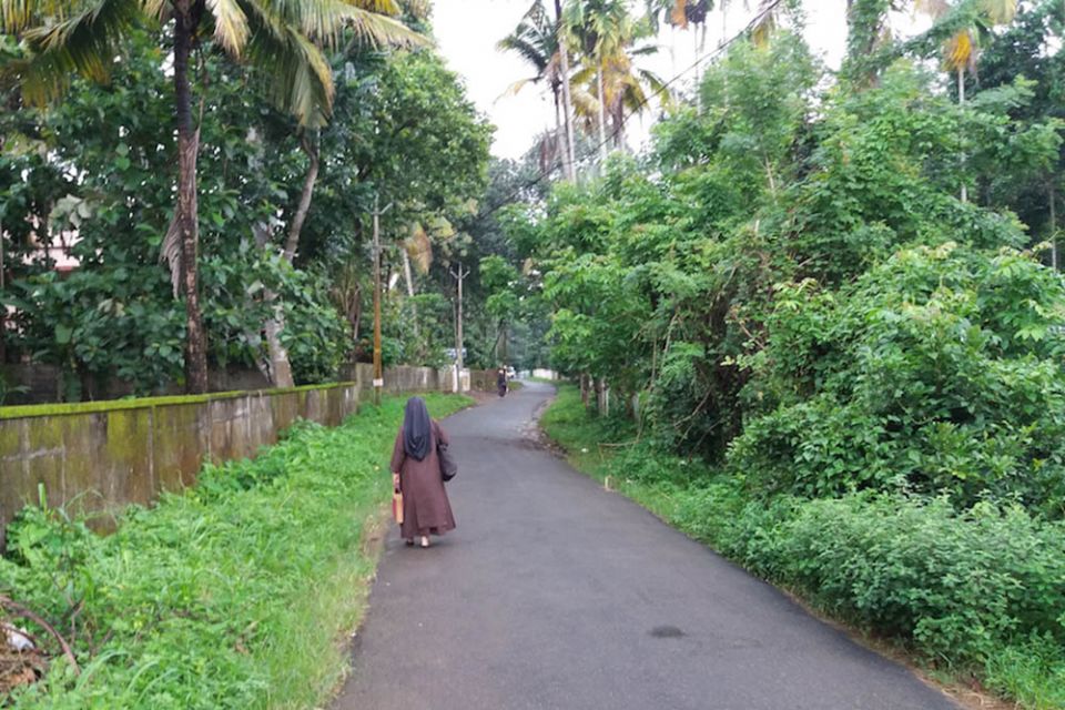 A Carmelite sister walks a country road during a Gospel Journey Campaign in Kerala, southern India, in 2019. (Philip Mathew)