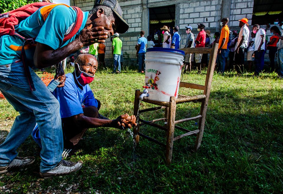 Haitians affected by the August 2021 earthquake in southern Haiti are seen in September at a Catholic Relief Services distribution site in the locality of Kay Raymond, Petit-Trou-de-Nippes, Haiti. (Catholic Relief Services/Georges Harry Rouzier)