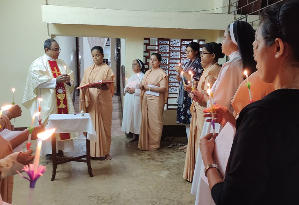 Members of the Congregation of the Sisters of Holy Family of Nazareth, Sancoale-Goa, India, hold candles as they celebrate the World Day of Prayer for Consecrated Life. (Molly Fernandes)