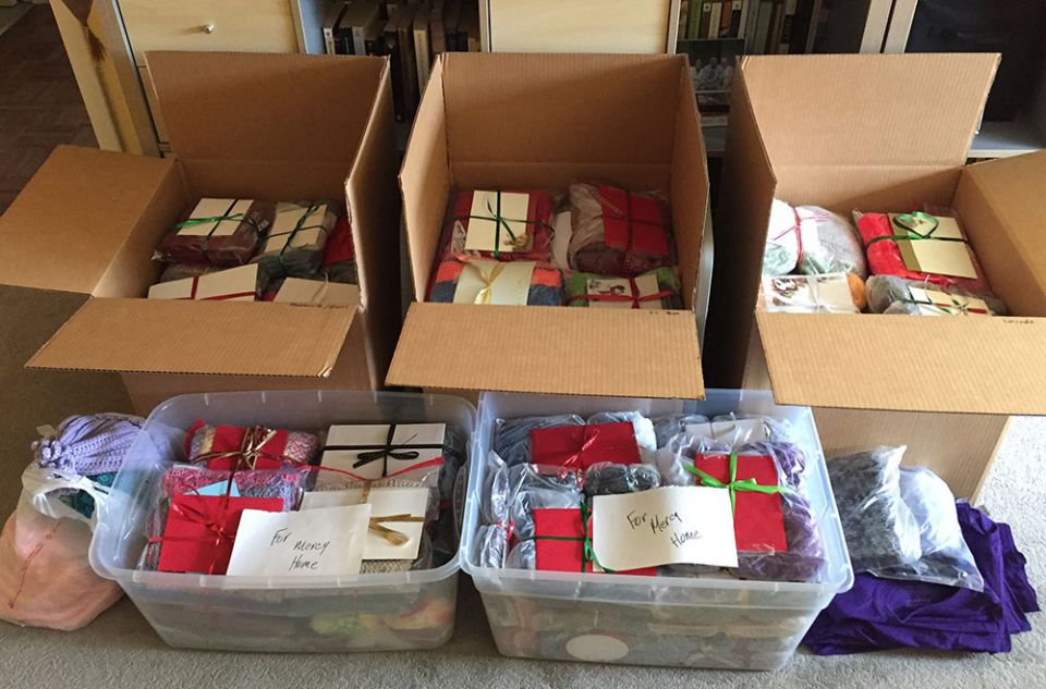 Knitted items from the St. Giles Prayer Shawl Ministry are ready to mail. (Courtesy of Susan Paweski)