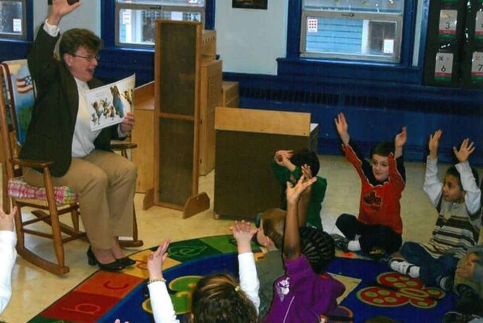 Jane Herb as superintendent, 1998 Sr. Jane Herb reads to a class in 1998, when she was the superintendent of Catholic schools in the Diocese of Albany, New York. (Courtesy of Jane Herb)