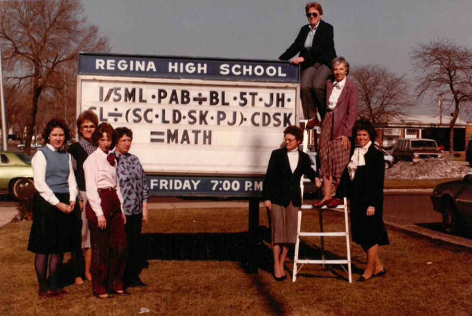 A picture from Regina High School's 1984 yearbook, when Sr. Jane Herb (top right, on ladder) was chair of the math department. The department members used their initials in an equation to spell out "MATH." (Courtesy of Jane Herb)