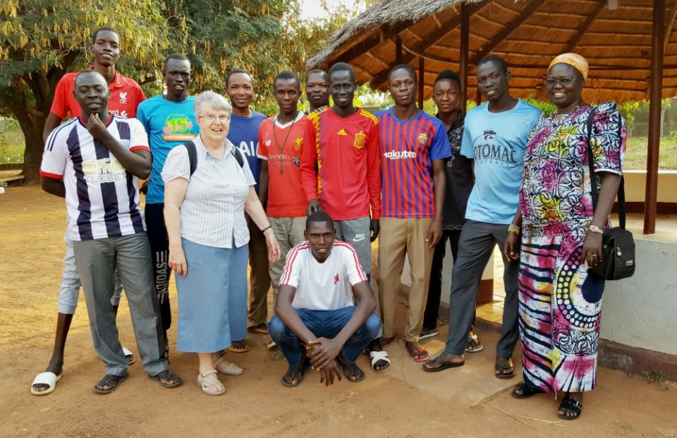 Sr. Joan Mumaw, standing front, with Sr. Esperance Bamiriyo, principal of the Catholic Health Training Institute in Wau, South Sudan, and a Comboni Missionary Sister, right, with 2019 graduates of the institute (Courtesy of Solidarity with South Sudan)