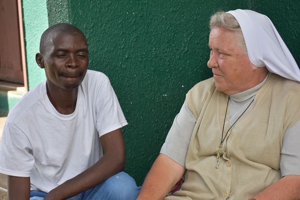 Sr. Judith Bozek chats with Bernard Mpundu, left, from Northern Province who recently found solace at the foster home after he was stranded in Lusaka. Mpundu was searching for employment and was attacked by robbers and left injured.