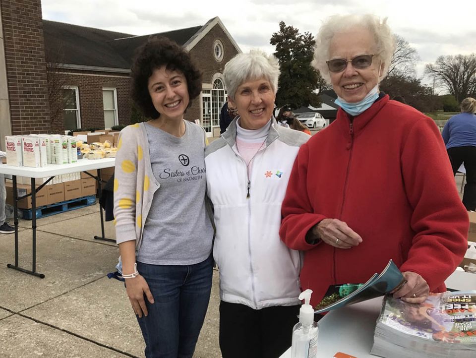 Julia Gerwe, left, embraces her call to serve with Srs. Susan Gatz, center, and Rosemarie Kirwan, at a November 2021 food distribution site in Nelson County, Kentucky, home of the Sisters of Charity of Nazareth. (Courtesy of Danielle Hagler)
