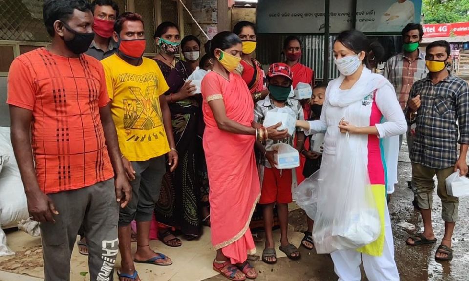 Sujata Jena at a bus stand in Bhubaneswar, meeting some workers of Kalahandi, Odisha, in India, who returned from Tamil Nadu, some 2,000 kilometers (1,240 miles) away from Odisha. She shared some food packs with them as they didn't have money to buy food 