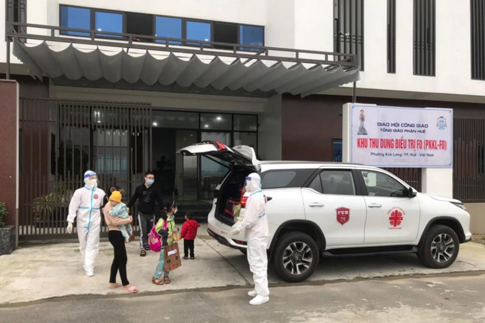 Religious volunteers in medical gear drive patients who have fully recovered from COVID-19 from Kim Long Charity Clinic in Kim Long ward in Hue, Vietnam, to their home Feb. 28. (Joachim Pham)