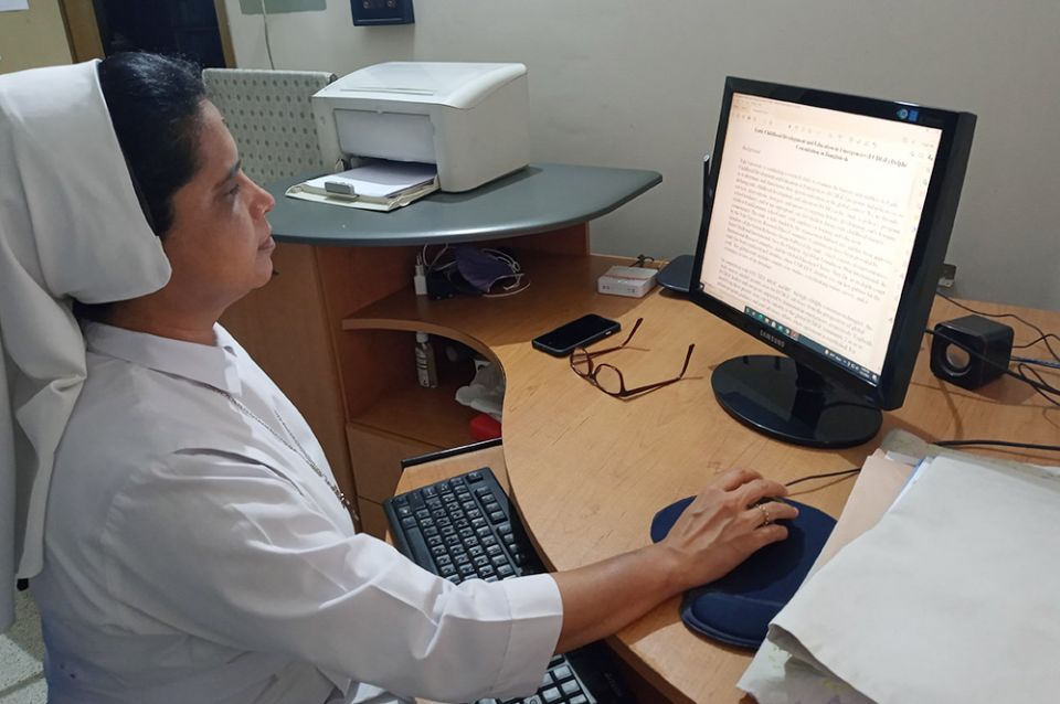 Sr. Lipy Gloria Rozario of the Sisters of Our Lady of Sorrows works in her office at the Healing Heart Counseling Unit in Dhaka, Bangladesh. (Sumon Corraya)