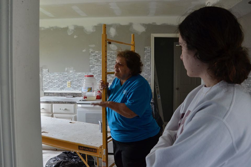 Sr. Luke Boiarski, left, and volunteer Lizzi Seyle speak May 23 to the owners of a home damaged by a December 2021 tornado in Mayfield, Kentucky. (GSR photo/Dan Stockman)