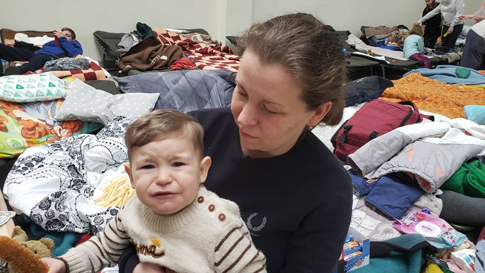 Two families who had just arrived March 8 in Korczowa, Poland, from Kharkiv, Ukraine, said they had no other choice but to leave. "We were scared, and especially scared for the child's sake," said Anastasia, seen here holding her a 1-year-old son, Nikita.