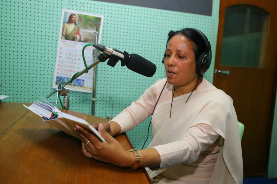 Sr. Mary Anna Gomes reads a script for a radio program for Radio Veritas Asia, Bengali Service. (Sumon Corraya)