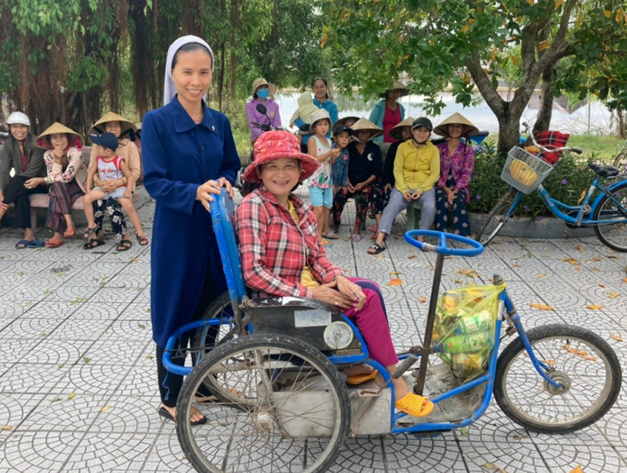 Sr. Mary Bui Thi Vinh of the Daughters of Our Lady of the Visitation with a woman who uses a wheelchair pose Oct. 30, 2021, in Hue, Vietnam. (Joachim Pham)