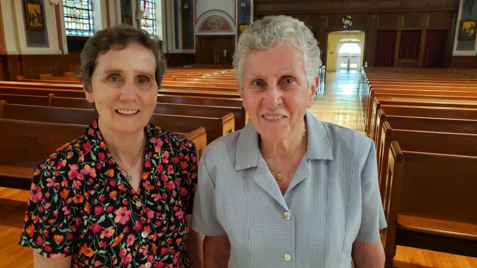 Sr. Mary Flood, left, and her older sister, Sr. Margaret Flood, pose in the chapel of the motherhouse of the Sisters of St. Dominic of Blauvelt, New York. (GSR photo/Chris Herlinger)