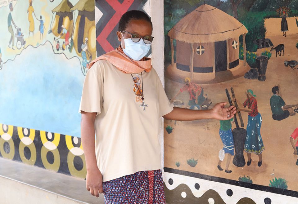 Sr. Anna Masawe explains an image that shows how a community should join together to help raise children. (GSR photo/Doreen Ajiambo) Sr. Anna Masawe explains an image that shows how a community should join together to help raise children. (GSR photo/Doreen Ajiambo)