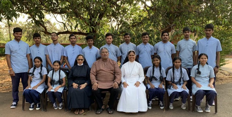 Sr Meena Dias, front row, in white, with Fr. Maverick Fernandes, director of Caritas, Goa and Sr. Monica Coelho, front row, in black, headmistress of St. Xavier's Academy in Old Goa, with their students (Provided photo)
