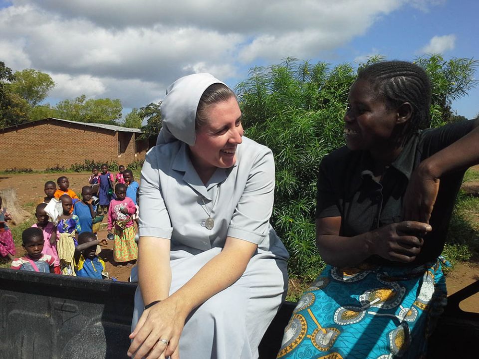Canossian Sr. Melissa Dwyer and chats with one of her secondary students at Bakhita Secondary School in Balaka, Malawi, in 2009. (Courtesy of Melissa Dwyer)