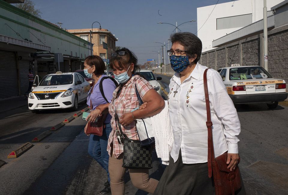 Interfaith Welcome Coalition volunteer Graciela Morgan, from left, El Buen Samaritano shelter coordinator Micaela Ortiz, and Sister Mercedes Castillo make their way through a busy intersection after crossing into Nuevo Laredo, Mexico, on March 27. Interfaith Welcome Coalition volunteer Graciela Morgan, from left, El Buen Samaritano shelter coordinator Micaela Ortiz, and Sister Mercedes Castillo make their way through a busy intersection after crossing into Nuevo Laredo, Mexico, on March 27.