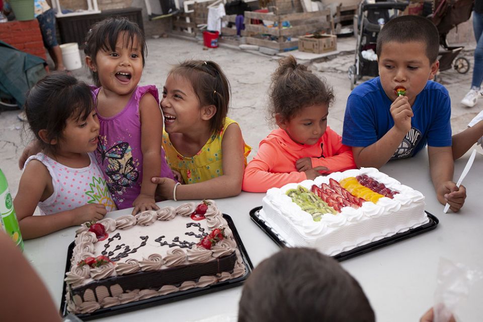 Birthday girl Ximena Lino Romero, 3, second from left, laughs with friends during a party for her and a friend at the El Buen Samaritano immigrant shelter in Nuevo Laredo, Mexico, on March 27. (Nuri Vallbona)