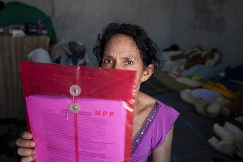 Maria Piñeda Serrano of Honduras shows the file that holds her Migrant Protection Protocols paperwork on March 27 at the El Buen Samaritano shelter in Nuevo Laredo, Mexico. (Nuri Vallbona)