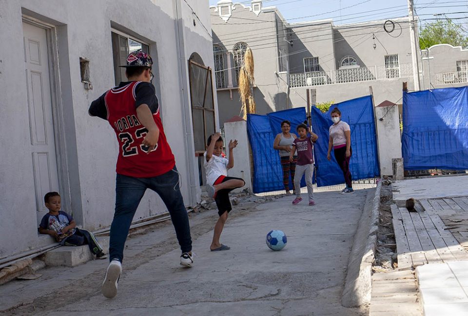 Locked gates keep children safe as they play soccer at the El Buen Samaritano shelter in Nuevo Laredo, Mexico, where immigrants are waiting their turn to seek asylum in the U.S. (Nuri Vallbona)