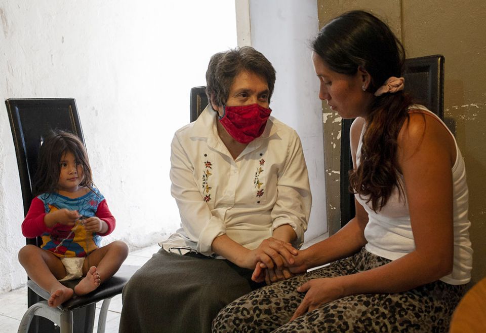 Sr. Mercedes Castillo, second from left, comforts Noelia Marlene Vásquez of Honduras while her daughter, Lindsey Gimena Rodas, 2, sits nearby at the El Buen Samaritano shelter in Nuevo Laredo, Mexico, on March 27. (Nuri Vallbona)