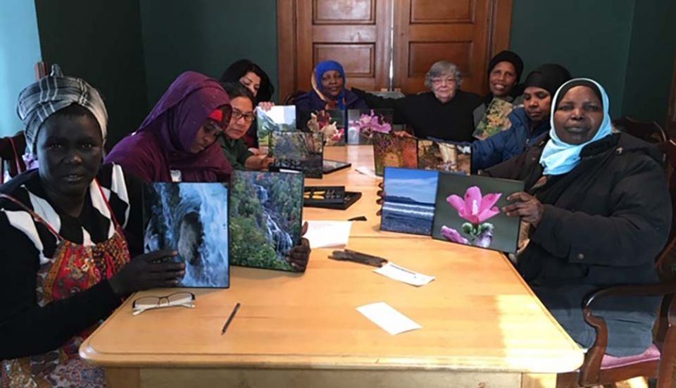 Some of the single moms gather at Mary's House to frame nature photos donated by a photographer and friend of the program. (Provided photo)