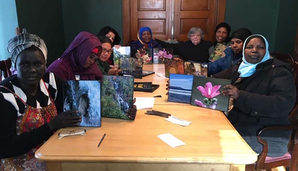 Some of the single moms gather at Mary's House to frame nature photos donated by a photographer and friend of the program. (Provided photo) Some of the single moms gather at Mary's House to frame nature photos donated by a photographer and friend of the program. (Provided photo)