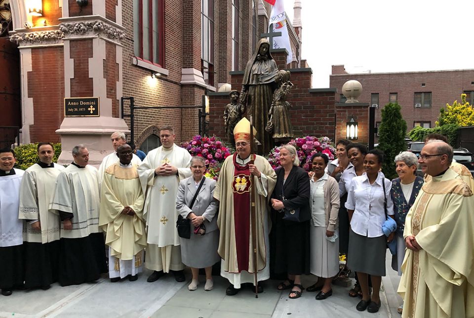 Bishop Nicholas DiMarzio stands with the members of the Missionary Sisters of the Sacred Heart of Jesus and others in attendance at the dedication of the new Mother Cabrini statue and shrine in the Carroll Gardens section of Brooklyn, New York. (Courtesy 