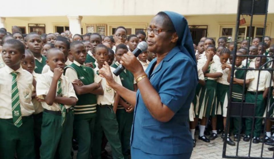 Sr. Bibiana Emenaha of the Daughters of Charity of St. Vincent de Paul speaks to students in February at a rural school in Edo, Nigeria, on the dangers of trafficking. (Courtesy of the Committee for the Support of Dignity of Women)