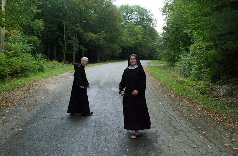 A Petersham Benedictine sister enjoys a walk with a monk of St. Mary's Monastery, which shares the sisters' campus. (Courtesy of the Order of St. Benedict-Petersham)