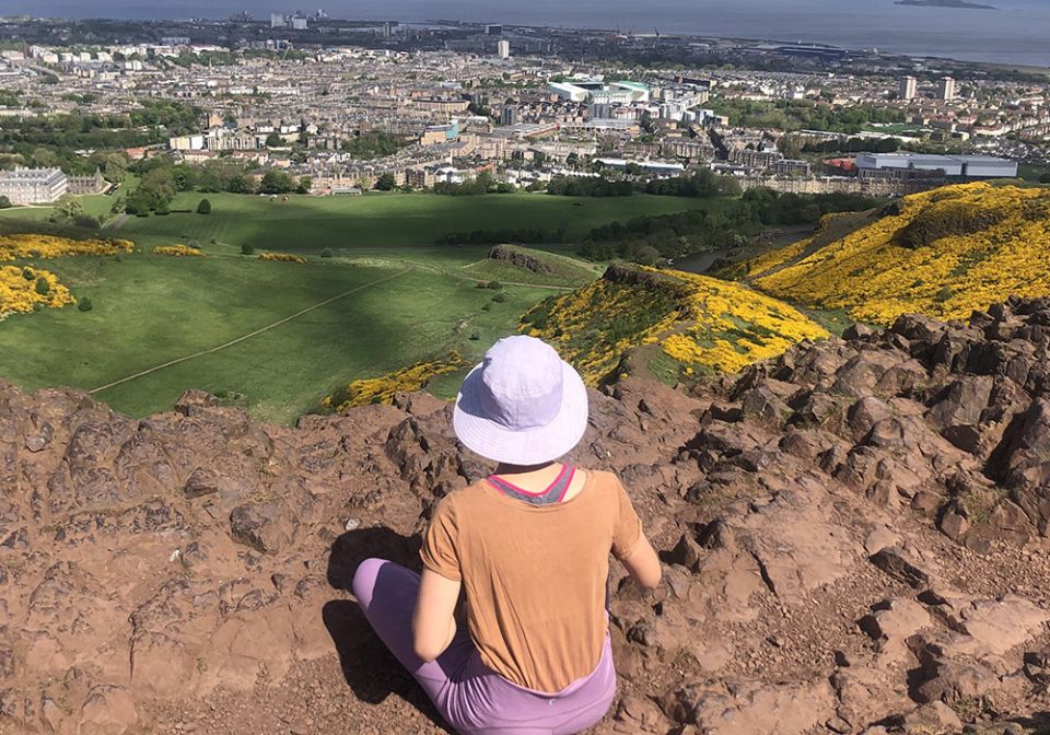 I pause to breathe and reflect atop Arthur's Seat in Edinburgh, a hike I recently took when visiting my friend Claire in Scotland. (Courtesy of Claire Kaelin)