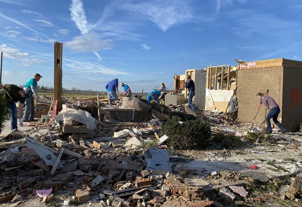 Volunteers with the Sisters of Charity of Nazareth sort through and clear debris from a home severely damaged by tornadoes in Campbellsville, Kentucky, accompanied by the surviving family and friends. (Courtesy of Ellen Sprigg) Volunteers with the Sisters of Charity of Nazareth sort through and clear debris from a home severely damaged by tornadoes in Campbellsville, Kentucky, accompanied by the surviving family and friends. (Courtesy of Ellen Sprigg)