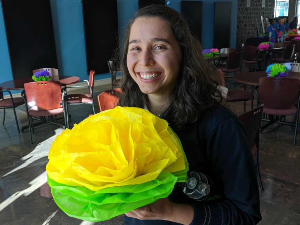 Sister Miriam poses with a Mexican paper flower at the Hope Border Institute's October teach-in she hosted. (Samantha Kominiarek)