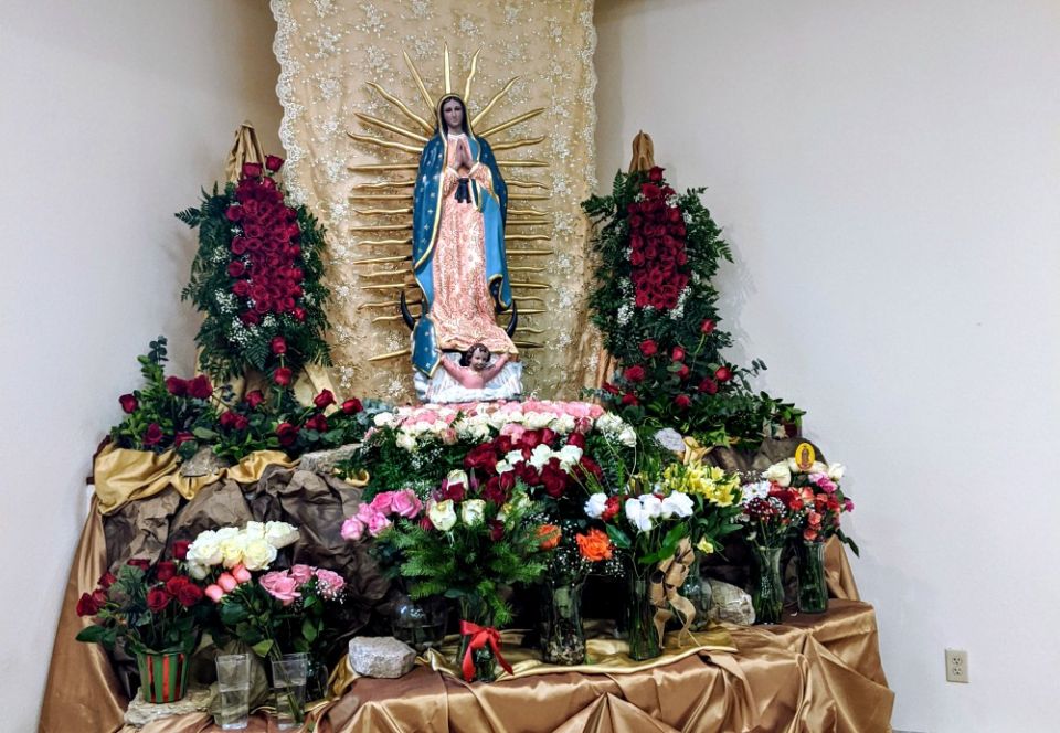 The beautiful Our Lady of Guadalupe statue at our church, covered with roses in her honor (Samantha Kominiarek)