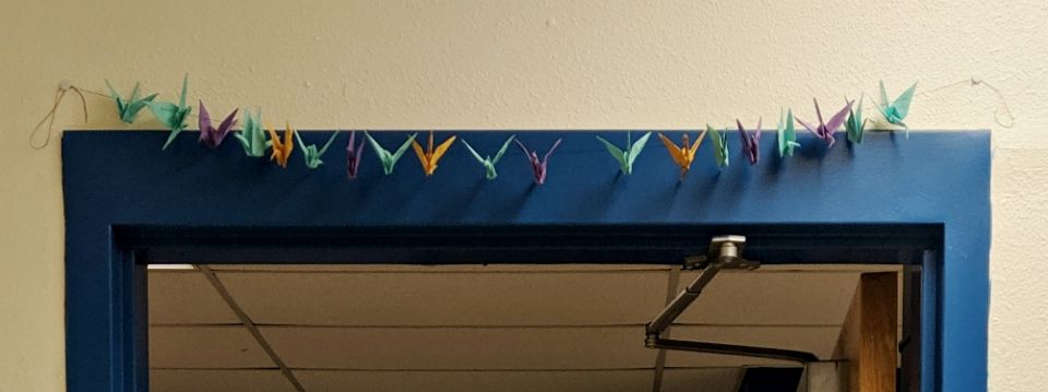 The cranes the seventh-graders made hang above the classroom door to remind students to enter and leave the classroom with a positive and peaceful attitude, just like Sadako. (Samantha Kominiarek)