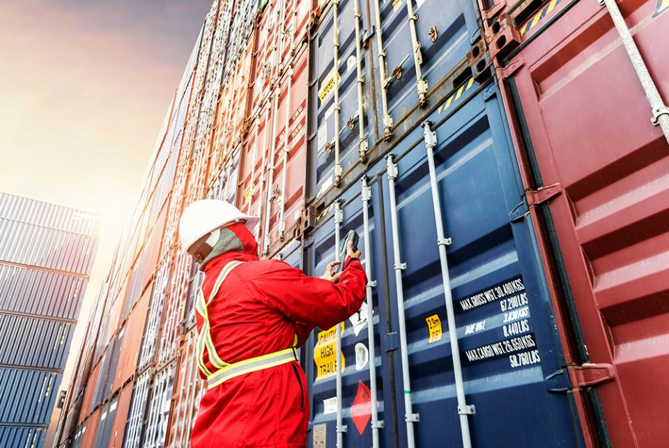 A seafarer checks containers in this photo illustration. Seafarers are responsible for delivering most food, medicine, and electronics around the world, but disembarking at most international ports has become an impossibility. (Courtesy of Solidarity with A seafarer checks containers in this photo illustration. Seafarers are responsible for delivering most food, medicine, and electronics around the world, but disembarking at most international ports has become an impossibility. (Courtesy of Solidarity with