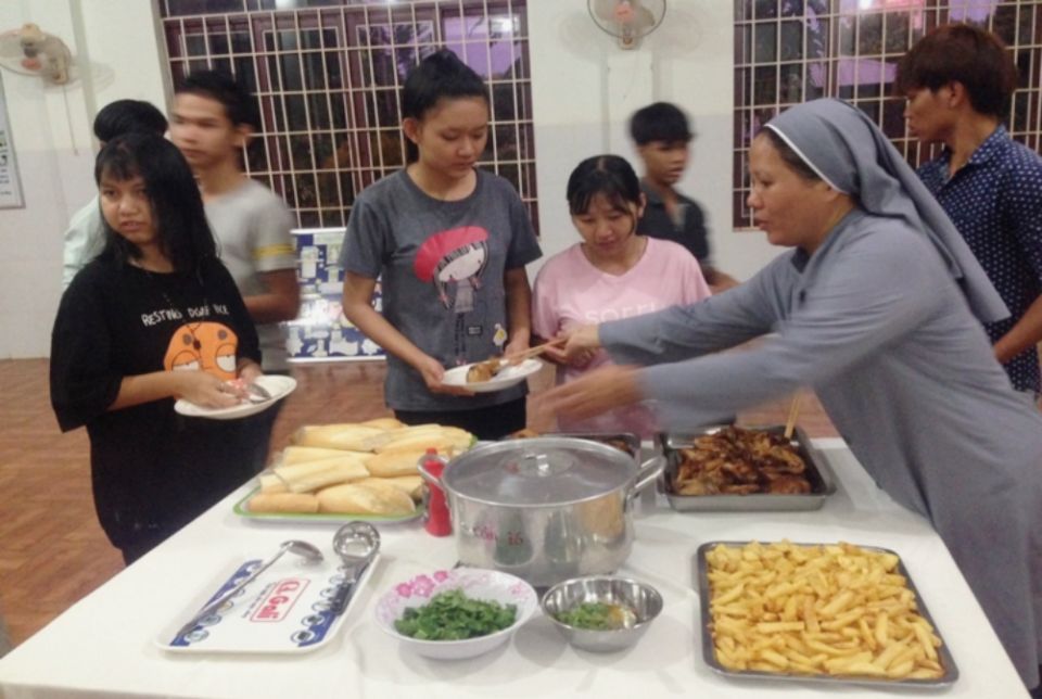 Sister Theresa helps students with their food at Vi Nhan School. (Leanne Hoang)