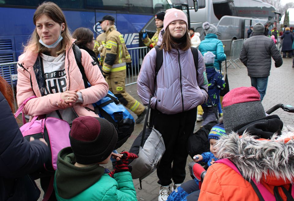 Ukrainians having arrived at a transit center in the border city of border city of Korczowa, Poland, wait for buses that will take them elsewhere to Poland or other countries in Europe. (GSR photo/Chris Herlinger)