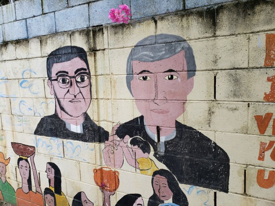A mural on a wall outside a youth center in Apopa, El Salvador, depicts Archbishop Óscar Romero, left, and Jesuit Fr. Rutilio Grande. The youth center is part of a project of sisters and others called the Color Movement. (GSR / Chris Herlinger) A mural on a wall outside a youth center in Apopa, El Salvador, depicts Archbishop Óscar Romero, left, and Jesuit Fr. Rutilio Grande. The youth center is part of a project of sisters and others called the Color Movement. (GSR / Chris Herlinger)
