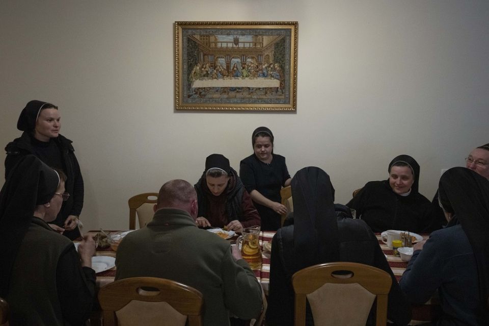 Nuns eat dinner April 6 at the Hoshiv Women Monastery, where they have been taking in internally displaced families fleeing the war in Ivano-Frankivsk region, western Ukraine.