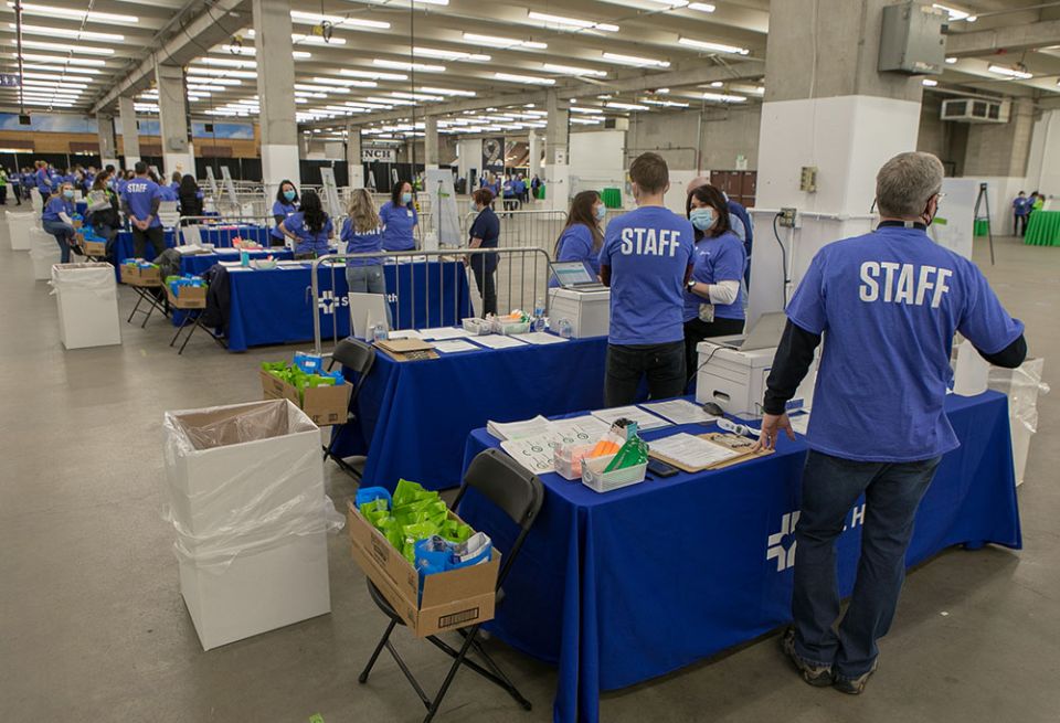 SCL Health associates prepare to check in patients at A Feb. 6 mass-vaccination clinic at the National Western Complex, a convention space in Denver. In 10 hours, 5,000 people were inoculated.