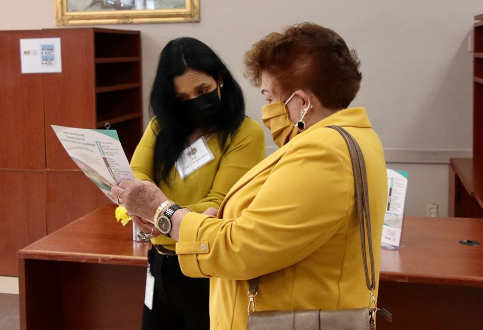 Social worker Pat Laffiton, left, talks with a parishioner at Our Lady of Guadalupe Parish in San Diego about the services offered at the Community Resource Center. (Courtesy of Adela Garcia)