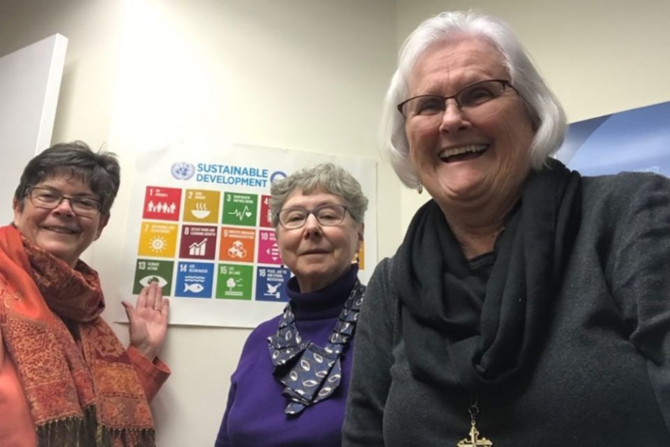 From left: Sacred Heart of Jesus Sr. Sheila Smith, St. Joseph Sr. Barbara Bozak and Dominican Sr. Dusty Farnan show a poster of the U.N. sustainable development goals after participating in the 66th Commission on the Status of Women.