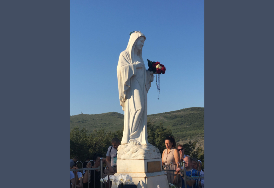 Pilgrims pray before a statue of Mary on Apparition Hill in Medjugorje, Bosnia-Herzegovina, in a photo from August 2022. (Kathryn Press)