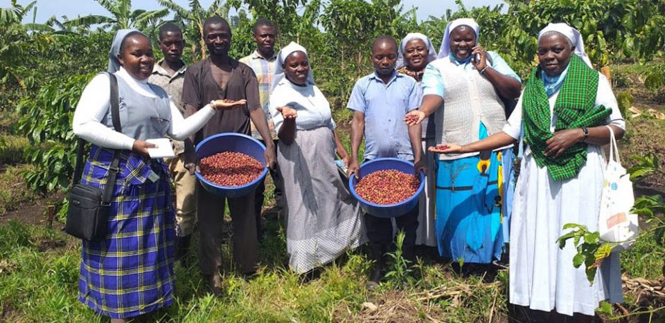 Sr. Celestine Nasiali (left), coordinator of the Sisters Blended Value Project, with sisters from the Daughters of St. Therese of the Child Jesus (Banyatereza Sisters), celebrate the coffee harvest in Fort Portal, Uganda. (Courtesy of Celestine Nasiali)
