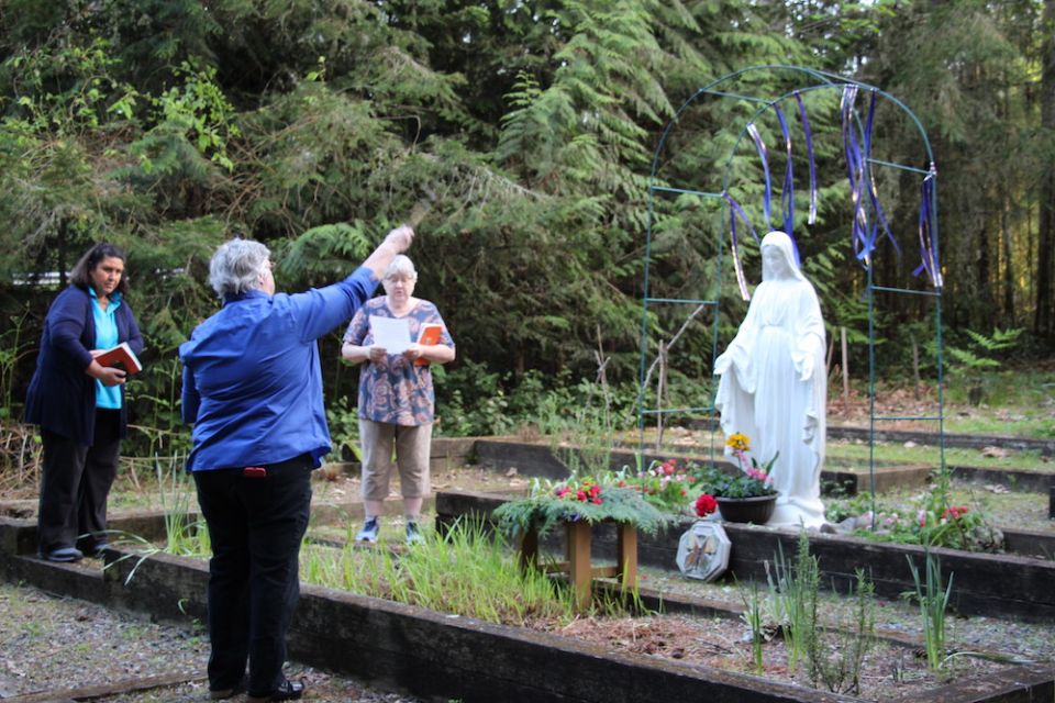 Some of the Benedictine Sisters of St. Placid Priory in Lacey, Washington, pray at a distance during an outdoor May crowning. (Courtesy of Benedictine Sisters of St. Placid Priory)