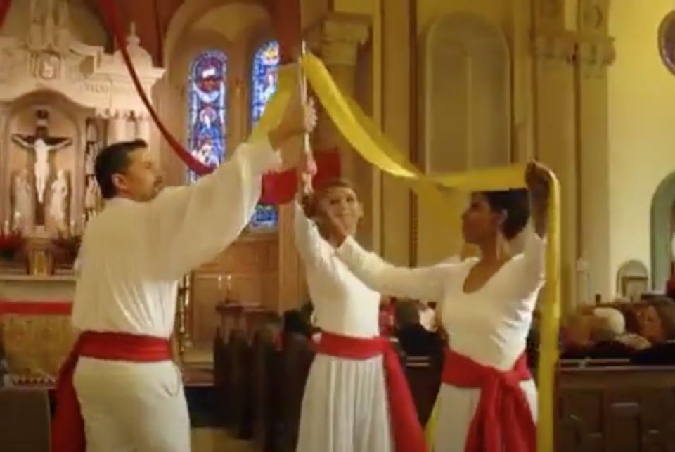 Three people in a church dancing