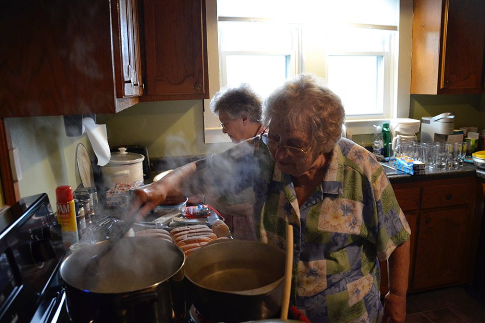 Srs. Thérèse Arru, left, and Louise Smith cook dinner for the Sisters of Charity of Nazareth's disaster recovery team May 23 in Fancy Farm, Kentucky. (GSR photo/Dan Stockman)